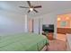 Well-lit bedroom with ensuite bathroom access and ceiling fan at 3634 Tripoli Cove Ave, Las Vegas, NV 89106