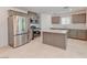 A kitchen featuring stainless steel appliances, an island, and tile flooring at 3634 Tripoli Cove Ave, Las Vegas, NV 89106