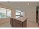 Island kitchen with white countertops and a view into the living room at 3634 Tripoli Cove Ave, Las Vegas, NV 89106