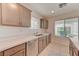 Kitchen featuring stainless steel appliances, a double sink, and granite countertops at 3634 Tripoli Cove Ave, Las Vegas, NV 89106