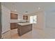 Open concept kitchen with island and stainless steel appliances at 3634 Tripoli Cove Ave, Las Vegas, NV 89106
