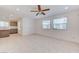 A living room area leading into a kitchen with tile floors and neutral walls at 3634 Tripoli Cove Ave, Las Vegas, NV 89106