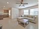 Bright living room, open to kitchen, with sectional sofa and coffee table at 3634 Tripoli Cove Ave, Las Vegas, NV 89106
