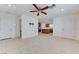 A living room area leading into a kitchen with tile floors and neutral walls at 3634 Tripoli Cove Ave, Las Vegas, NV 89106