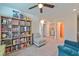 Open loft area with seating, bookshelves, and access to bathroom and laundry at 3634 Tripoli Cove Ave, Las Vegas, NV 89106