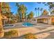 Community pool and spa area surrounded by lush landscaping and a sun deck at 3950 S Sandhill Rd # 112, Las Vegas, NV 89121