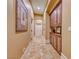 Hallway featuring tile floors, wall decor, with a hallway cabinet for storage at 453 Via Palermo Dr, Henderson, NV 89011