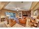 Bright living room with a stone fireplace and seamless access to the outdoor patio at 453 Via Palermo Dr, Henderson, NV 89011