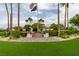 Beautiful clubhouse entrance framed by palm trees and manicured landscaping, creating a welcoming atmosphere at 5805 Hannah Brook St, North Las Vegas, NV 89081