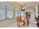 Airy dining room featuring a wooden dining set, high ceilings, and a view of the outdoor patio at 5805 Hannah Brook St, North Las Vegas, NV 89081