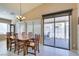 Bright dining area with a wooden table, seating for six, and a sliding glass door leading to the patio at 5805 Hannah Brook St, North Las Vegas, NV 89081