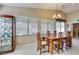 Bright dining room with a wooden table, seating for six, and large windows offering ample natural light at 5805 Hannah Brook St, North Las Vegas, NV 89081