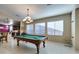 Well-lit game room features a classic pool table and large windows with blinds at 5805 Hannah Brook St, North Las Vegas, NV 89081