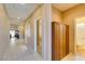 Bright hallway features neutral walls, tile flooring, and built-in storage, connecting various rooms at 5805 Hannah Brook St, North Las Vegas, NV 89081