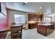 Spacious kitchen with an island, wooden cabinets, and white tile floors at 5805 Hannah Brook St, North Las Vegas, NV 89081