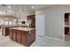 A gourmet kitchen offers an island with marble counter tops and stainless appliances at 5805 Hannah Brook St, North Las Vegas, NV 89081