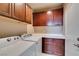 Functional laundry room with washer, dryer, cabinets and countertop at 5805 Hannah Brook St, North Las Vegas, NV 89081