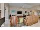 Bright living room features a large TV, comfortable seating, and neutral color palette at 5805 Hannah Brook St, North Las Vegas, NV 89081