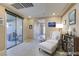 Comfortable living room with tiled floors, sliding glass doors to the patio, and built-in bookcase at 5805 Hannah Brook St, North Las Vegas, NV 89081