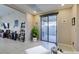 Inviting living area with tiled floor, sliding glass doors to outdoor patio, and neutral decor at 5805 Hannah Brook St, North Las Vegas, NV 89081