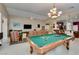 Open living space includes a pool table, comfortable seating, and seamless flow to the kitchen at 5805 Hannah Brook St, North Las Vegas, NV 89081