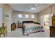 Spacious main bedroom with neutral walls, ceiling fan and access to the bathroom with a tub at 5805 Hannah Brook St, North Las Vegas, NV 89081