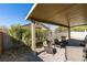 Cozy covered patio with stone flooring and comfortable seating, perfect for outdoor relaxation at 5805 Hannah Brook St, North Las Vegas, NV 89081