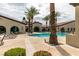 Resort-style pool area with lounge chairs and palm trees, creating a relaxing oasis at 5805 Hannah Brook St, North Las Vegas, NV 89081