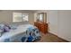 Bedroom with a window, dresser and flower patterned bedding on the bed at 604 Bryant Ct, Boulder City, NV 89005