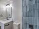 Modern bathroom with blue tile shower and updated vanity at 617 Carpenter Dr, Las Vegas, NV 89107