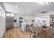 Bright kitchen featuring white cabinetry, stainless appliances, large island, and adjacent dining area at 617 Carpenter Dr, Las Vegas, NV 89107