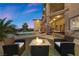 Backyard featuring a fire pit, seating area, and a view of the home with a balcony and spiral staircase at 670 Du Fort Ave, Henderson, NV 89002