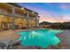 Large backyard with a pool, hot tub, mature landscaping, and covered seating area at 670 Du Fort Ave, Henderson, NV 89002