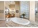 Close up on jacuzzi bathtub with granite border, tile, and jets, a luxurious focal point at 670 Du Fort Ave, Henderson, NV 89002