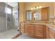 Granite vanity, framed mirror, and glass shower are shown in this luxurious bathroom at 670 Du Fort Ave, Henderson, NV 89002