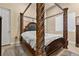 Elegant bedroom featuring a four-poster bed with detailed carvings and a plush rug at 670 Du Fort Ave, Henderson, NV 89002