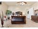 Spacious bedroom showcases a large, dark wood bed and a sitting area creating a cozy and inviting atmosphere at 670 Du Fort Ave, Henderson, NV 89002