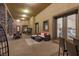 Spacious covered patio with seating, dining area, stone columns, and views of the backyard at 670 Du Fort Ave, Henderson, NV 89002