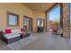 Comfortable covered patio area with stylish seating, a bar, and views of the landscaped backyard at 670 Du Fort Ave, Henderson, NV 89002