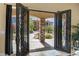View through ornate iron double front doors to backyard, pool, and covered patio at 670 Du Fort Ave, Henderson, NV 89002