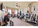 Home exercise room featuring ceiling fan, a variety of workout equipment, and natural light at 670 Du Fort Ave, Henderson, NV 89002
