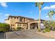 Luxury home with stone accents, a porte cochere, and lush landscaping offering curb appeal at 670 Du Fort Ave, Henderson, NV 89002