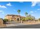Stately home with stone accents and a gated entrance, set against a backdrop of blue skies at 670 Du Fort Ave, Henderson, NV 89002