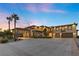 Expansive driveway leads to this home featuring a stone porte cochere and multi-car garage at 670 Du Fort Ave, Henderson, NV 89002