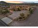 Aerial view of a large, luxurious home with a circular driveway, mature trees, and manicured landscaping at 670 Du Fort Ave, Henderson, NV 89002