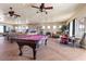 Large game room with a pool table, sitting area, stone fireplace, and entertainment options at 670 Du Fort Ave, Henderson, NV 89002