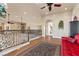 Second story hallway with decorative iron railing, hardwood floors, and access to multiple rooms at 670 Du Fort Ave, Henderson, NV 89002