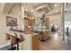 Spacious kitchen featuring wood cabinets, granite countertops, stainless steel appliances, and a convenient breakfast bar at 670 Du Fort Ave, Henderson, NV 89002