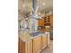 Modern kitchen island with gas cooktop and stainless hood, granite counters, and ample cabinet space at 670 Du Fort Ave, Henderson, NV 89002