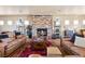 Spacious living room featuring leather sofas, a stone fireplace, and ample natural light at 670 Du Fort Ave, Henderson, NV 89002